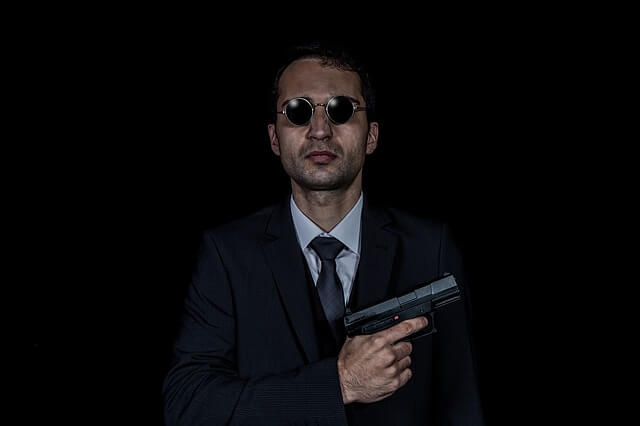 Man in suit with gun
