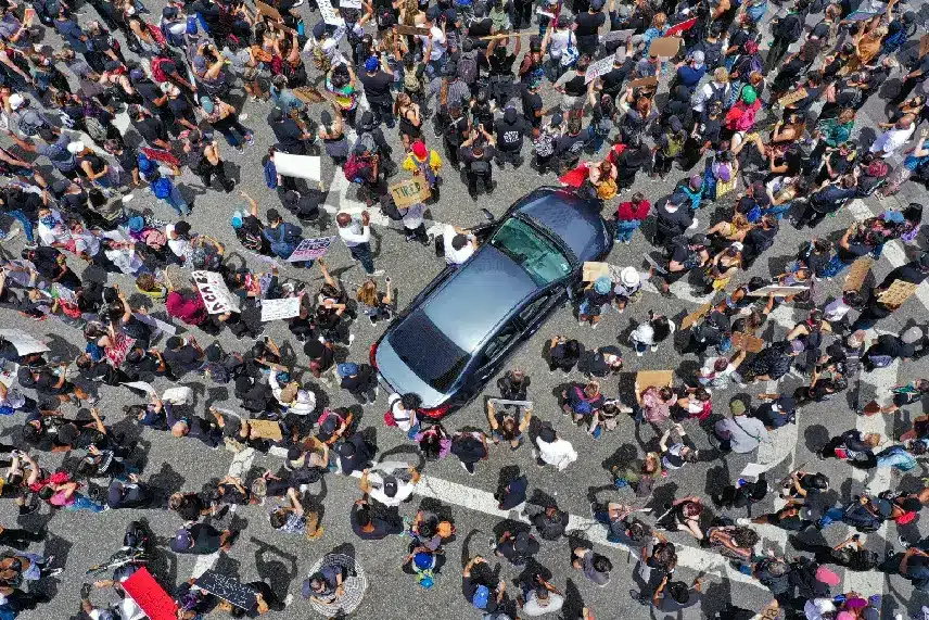 Rioters surround car